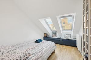 a bedroom with two beds and two windows at spacious and bright apartment in Bordeaux +9 photos