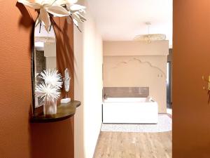 a bathroom with a white tub and a sink at Les 1001 nuits in Albi