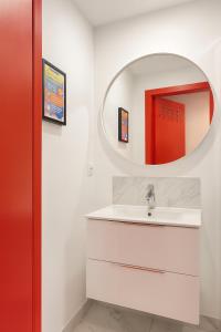 a bathroom with a white sink and a mirror at Chambre privée "Jaune" - Maison partagée in Amiens +4 photos