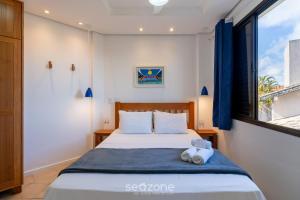 a bedroom with a bed and a window at Apto com Vista Mar a 214m da Praia - BLU0206 in Florianópolis