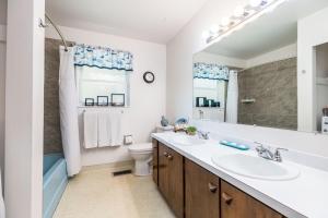 a bathroom with two sinks and a large mirror at Dimple Dell Whole Mountain Setting, Near Trails! in Sandy +80 photos