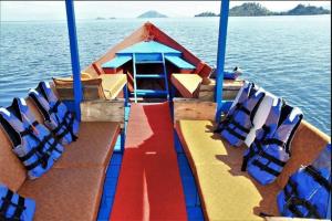 a boat with chairs sitting on the water at Lake kivu Boat Services in Gisenyi
