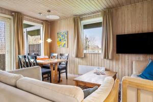 a living room with a couch and a table at 20125-Samso-Spaetmejsevej-2 in Nordby