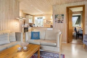 a living room with a couch and a table at 20125-Samso-Spaetmejsevej-2 in Nordby