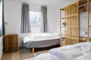 a bedroom with two beds and a window at 20125-Samso-Spaetmejsevej-2 in Nordby
