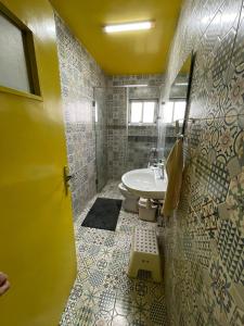 a bathroom with a sink and a toilet at Triplex of art and serenity in Kouas