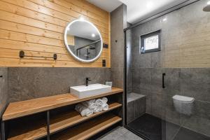 a bathroom with a sink and a mirror at Domki Salamandra Lipowa in Lipowa +25 photos