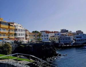a group of buildings next to a body of water at Surf Harbour Homestay in Los Abrigos