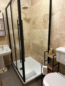 a bathroom with a shower and a toilet and a sink at Harringtons in Nottingham
