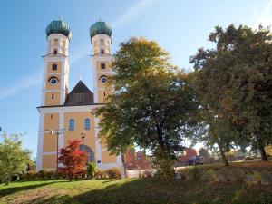 a church with two towers with a clock on it at Parkhotel Pfarrkirchen in Pfarrkirchen