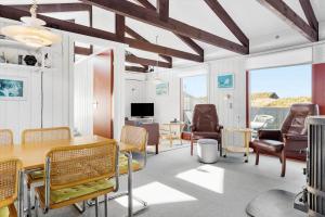 a living room with a table and chairs at TV1532-Skagen-Solbakken-55 in Skagen