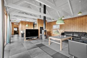 a living room with a couch and a tv at TV1658-Skagen-Klyngen-10 in Skagen