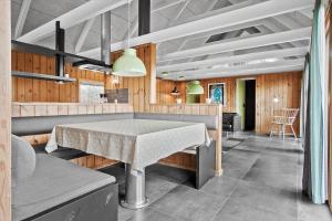 a dining room with a table and a kitchen at TV1658-Skagen-Klyngen-10 in Skagen +21 photos