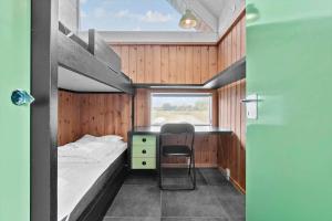 a small room with a bed and a chair in it at TV1658-Skagen-Klyngen-10 in Skagen