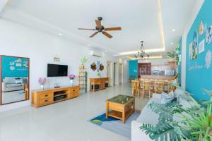 a living room with a couch and a dining room at Oasky Vũng Tàu 3 bedrooms - Pooh House 2 in Vung Tau
