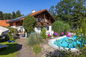 a house with a swimming pool in the yard at Haus Mona **** in Bad Heilbrunn
