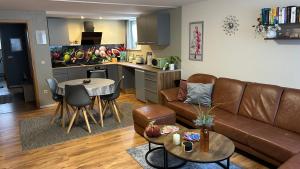 a living room with a couch and a table and a kitchen at Fewo Stein in Altenbeken