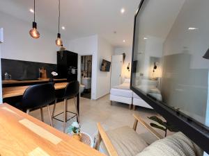 a living room with a table and a dining room at Goldstadt Apartments in Pforzheim