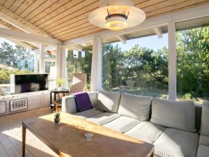 a living room with a couch and a large window at 4 star holiday home in Fjerritslev in Fjerritslev