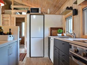 a kitchen with a white refrigerator in a room at 4 star holiday home in Fjerritslev in Fjerritslev