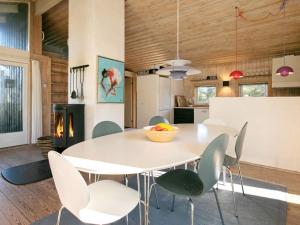 a kitchen and dining room with a white table and chairs at 4 star holiday home in Fjerritslev in Fjerritslev +37 photos