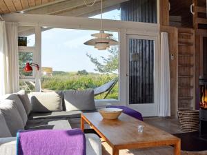 a living room with a couch and a table at 4 star holiday home in Fjerritslev in Fjerritslev