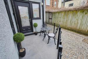 a patio with a table and chairs in front of a door at Great Ayton Townhouse Retreat-Sleeps 6-3Bed-2Bath in Great Ayton +46 photos