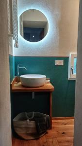 a bathroom with a sink and a mirror at Il Sensalino in San Donato in Poggio +10 photos