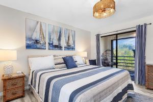 a bedroom with a bed and a balcony at Unwind with Beach Bliss & Sunset Magic - Sunburst 113 in Punta Gorda Beach