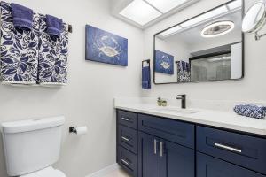 a bathroom with a sink and a mirror at Unwind with Beach Bliss & Sunset Magic - Sunburst 113 in Punta Gorda Beach +44 photos