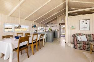a dining room and kitchen with a table and chairs at LN1566-Hirtshals-Kloren-17 in Hirtshals +14 photos