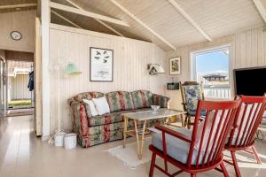 a living room with a couch and a table at LN1566-Hirtshals-Kloren-17 in Hirtshals