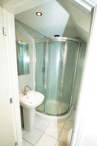 a bathroom with a shower and a sink at 3 Bed Semi - Sleeps 5 - Wifi - Private Garden & Parking - Pets Allowed in Grove Park +12 photos