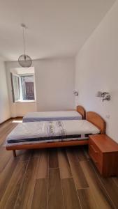 a large bed in a room with a wooden floor at Al Campanile a stylish new apartment San Vito Romano Rome in San Vito Romano +25 photos