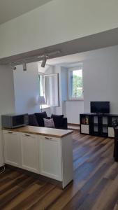 a living room with a couch and a table at Al Campanile a stylish new apartment San Vito Romano Rome in San Vito Romano