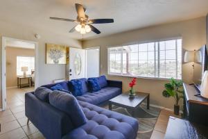 a living room with blue couches and a ceiling fan at 4 Mi to Dtwn San Diego Cozy Getaway with Patio! in San Diego