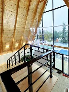 a room with a dining table and a large window at ES A frame in Gabala