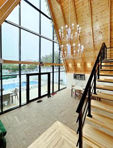 a large room with windows and a chandelier at ES A frame in Gabala +36 photos