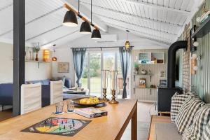 a kitchen and living room with a wooden table at BL1074-Saltum-Solmarken-3 in Saltum