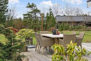 a table and chairs sitting on a wooden patio at BL1074-Saltum-Solmarken-3 in Saltum