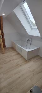 a white bath tub in a room with a window at Wustermark Ferienwohnung Dorfanger 8 in Wustermark