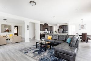 a living room with a couch and a table at Luxury Home Near Mckinney Falls & Airport in Austin +28 photos