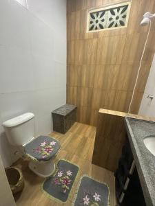 bagno con servizi igienici, lavandino e tappetini. di Casa do Bento - Lençóis Maranheses a Santo Amaro