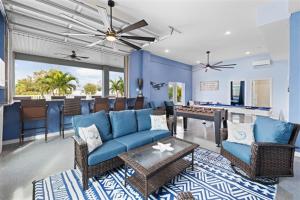 a living room with blue furniture and a pool table at Spacious Home With Heated Pool! Sleeps 15! Billiard table! in Hernando Beach