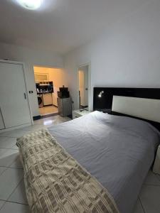 a bedroom with a large bed in a room at Studio 102-108 in Banī Ghālib +5 photos