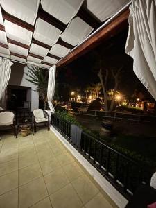 a patio with a view of the city at night at Studio 102-108 in Banī Ghālib