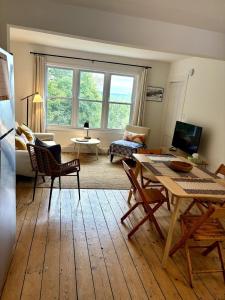 a living room with a table and a couch at Private duplex on Hudson River in Coxsackie