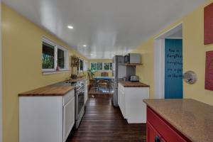 a kitchen with yellow walls and white appliances at The Whiskey River Lodge in Madison