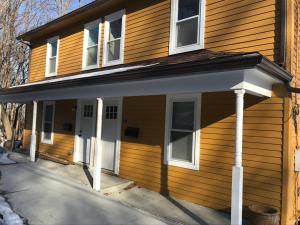 a front porch of a house with white columns at Private duplex on Hudson River in Coxsackie