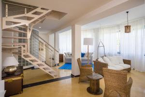 a living room with a spiral staircase in a house at Cinque Terre Moneglia Apartments in Moneglia